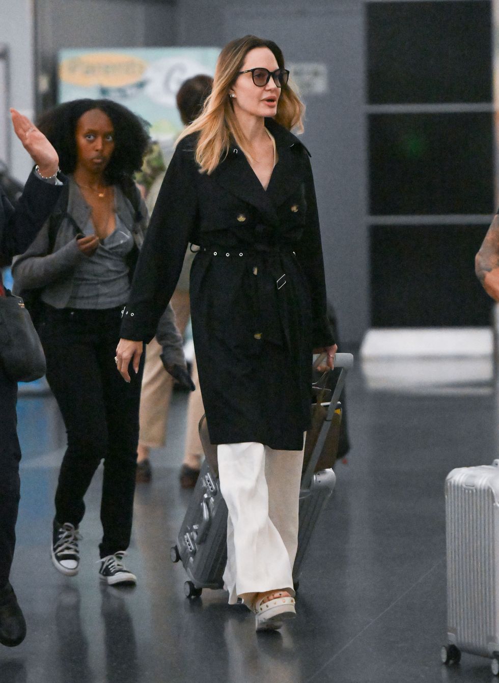 Angelina Jolie looks elegant in black as she walks through airport