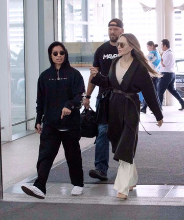 angelina jolie and pax walk through airport