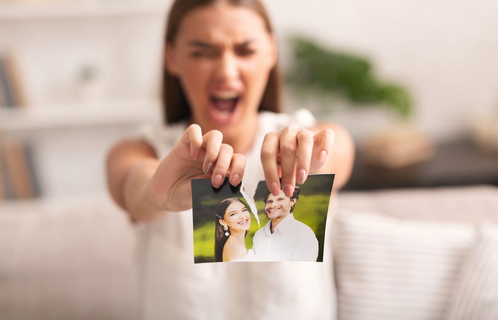 Angry Woman Ripping Photo With Ex-Husband Indoor