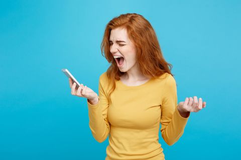 red hair woman screaming into phone