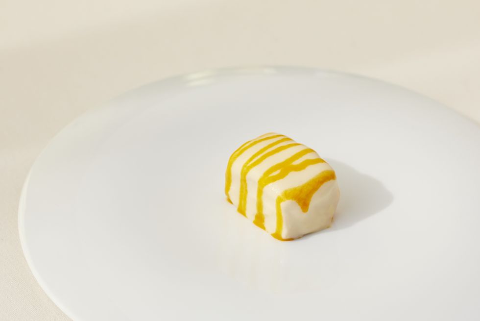 a white plate with a yellow substance on it