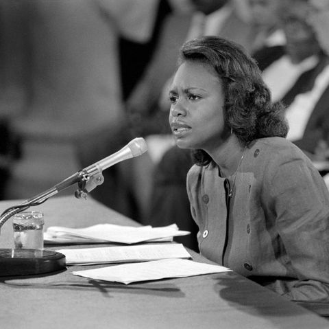 anita hill speaking into a microphone