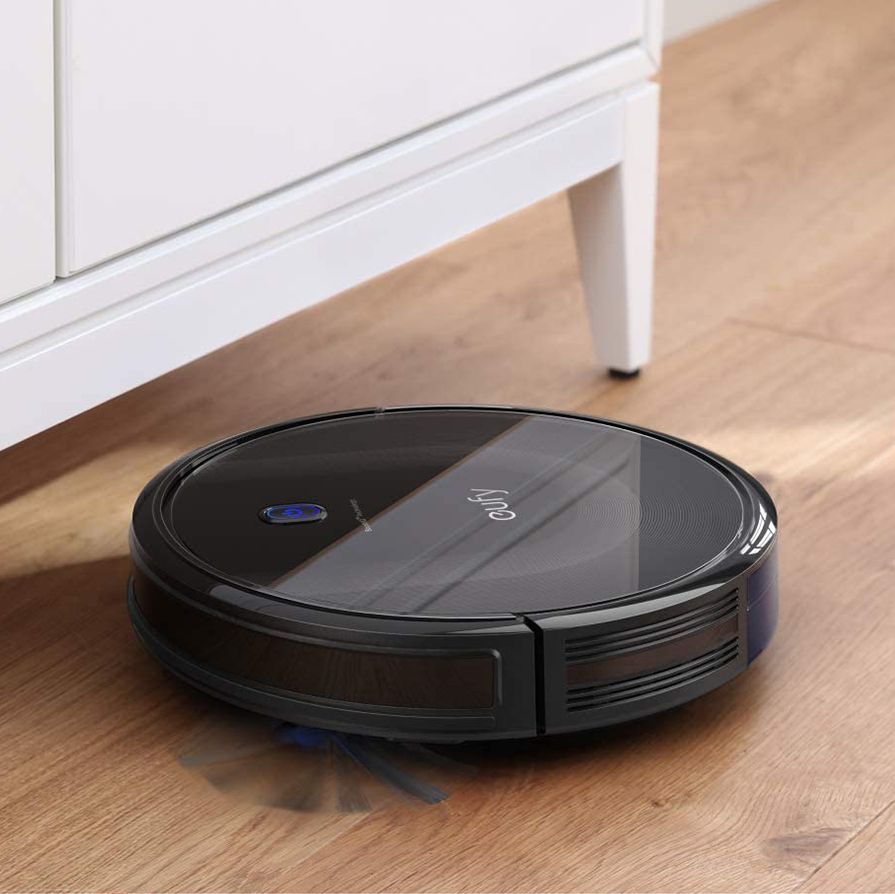eufy by anker boostiq robovac on wood floor under cabinet