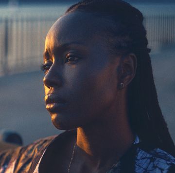 anna diop stars in nanny , a woman looks sadly out to sea