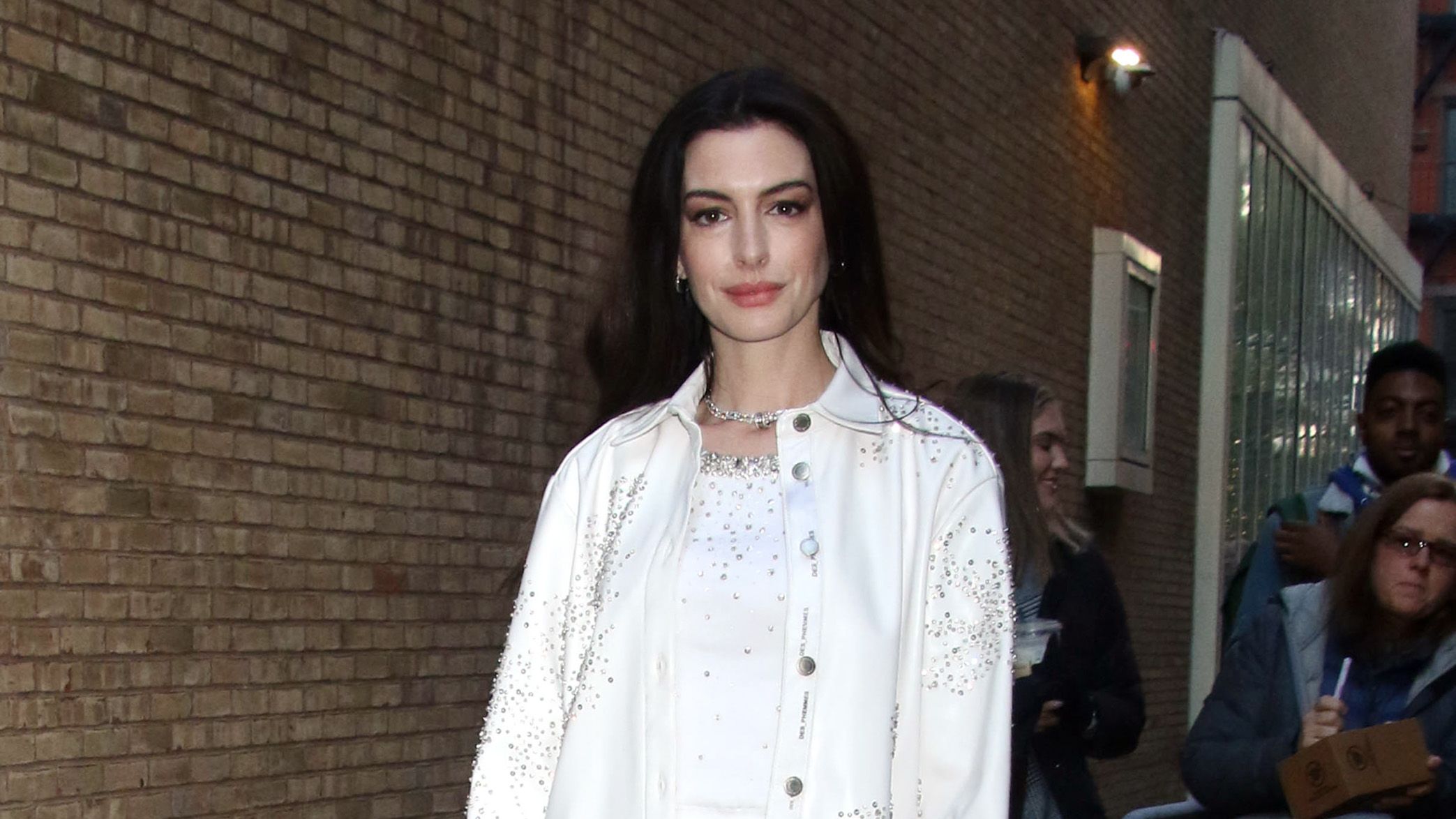 Anne Hathaway wears white cargos, heels and rhinestone crop top