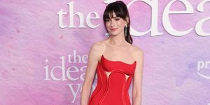 anne hathaway wears a custom made versace gown for the premiere of the idea of you the dress features a cut out corset bodice