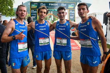 a group of men wearing blue and white running suits