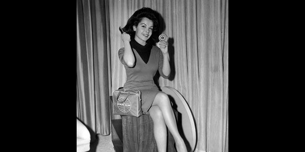 Annette Funicello: The teen idol primps for the camera at John F. Kennedy Internartional Airport in New York before embarking on a European publicity tour for Muscle Beach Party. The 1964 beach party movie also featured 13-year-old Stevie Wonder in his film debut. (Photo by Hulton Archive/Getty Images)