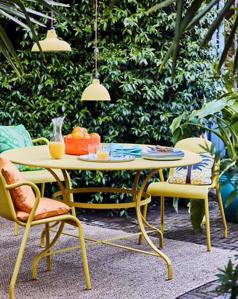 Furniture, Table, Patio, Outdoor table, Outdoor furniture, Chair, Yellow, Room, Leisure, Tree, 