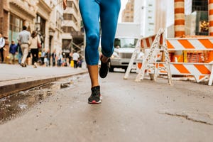 anonymous caucasian woman running on the streets of new york