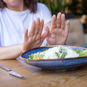 anonymous woman refuses from food,concept of eating disorder.
