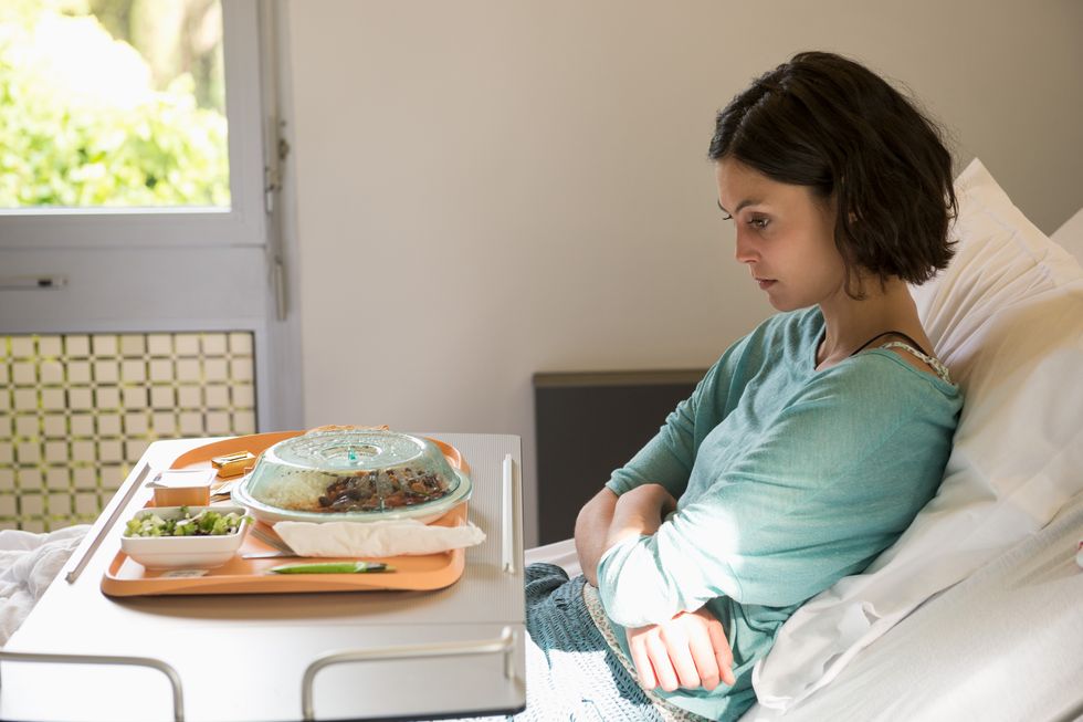 anorexia nervosa patient with a food tray in hospital ward