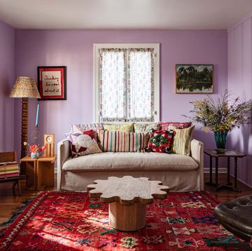 living room with purple walls and patterned accents