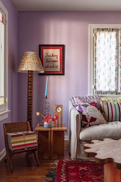purple living room with wooden standing lamp and furniture