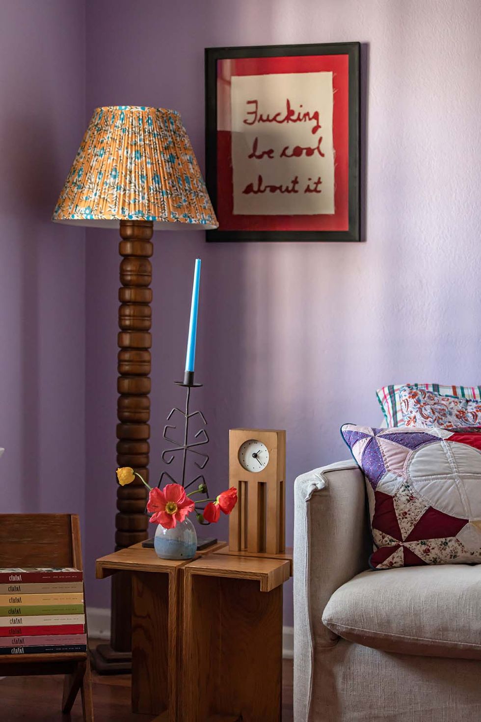 living room corner with purple walls and standing lamp