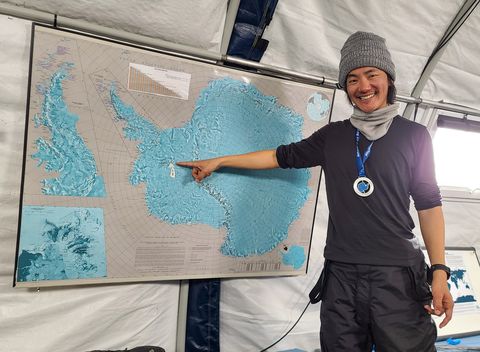 jeff tan in anartica next to map