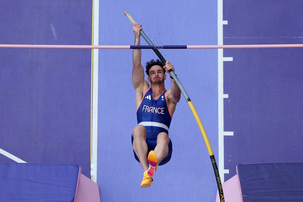downward angle of anthony ammirati gripping a pole during his olympic vault