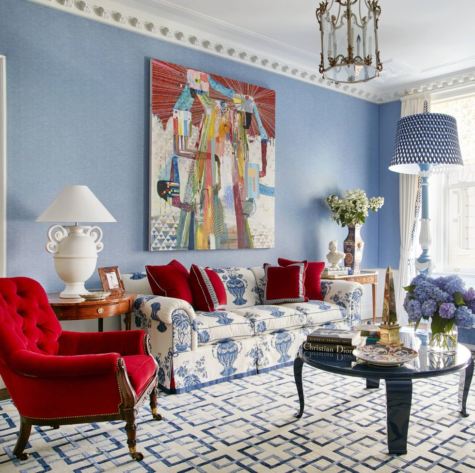 equally ample upholstered furnishings are clad in arresting colors and patterns including cherry red velvet and the sofas blockprinted linen while plaster and marble objects echo the color and classical tone of the original ceiling moldings the medallion border on the drapes was inspired by one in a christian lacroix showroom