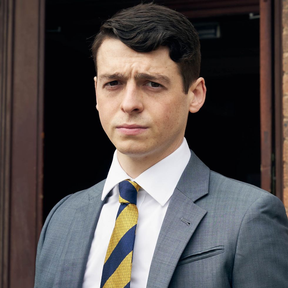 anthony boyle as brian wood standing outside court, looking directly into the camera in danny boy, bbc