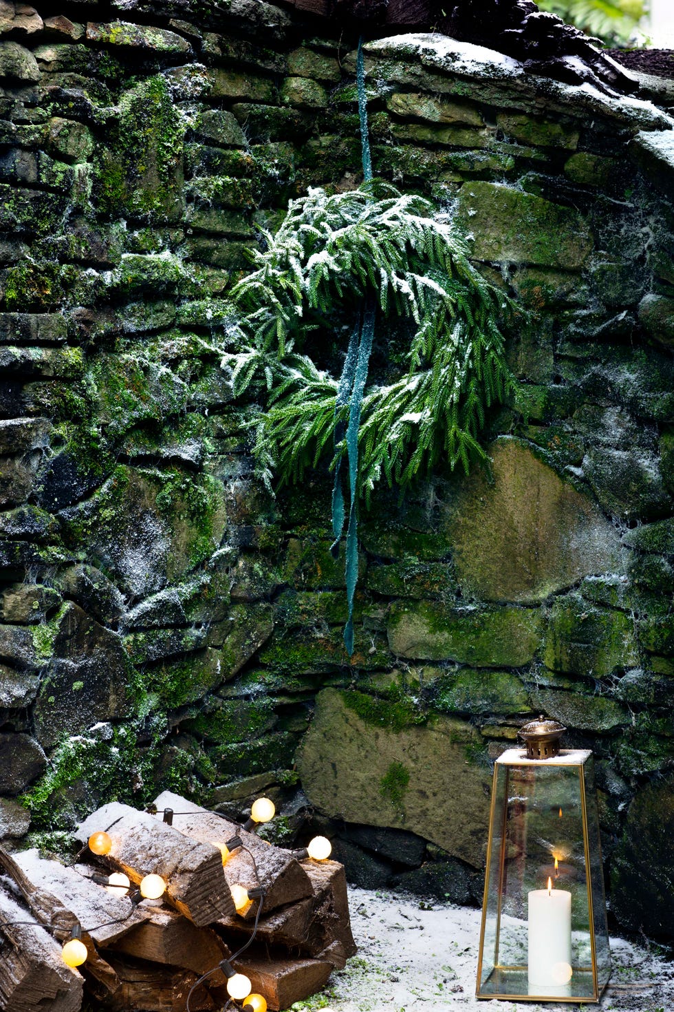 festive winter scene a festive winter scene with a wreath a candle lantern and decorative lights