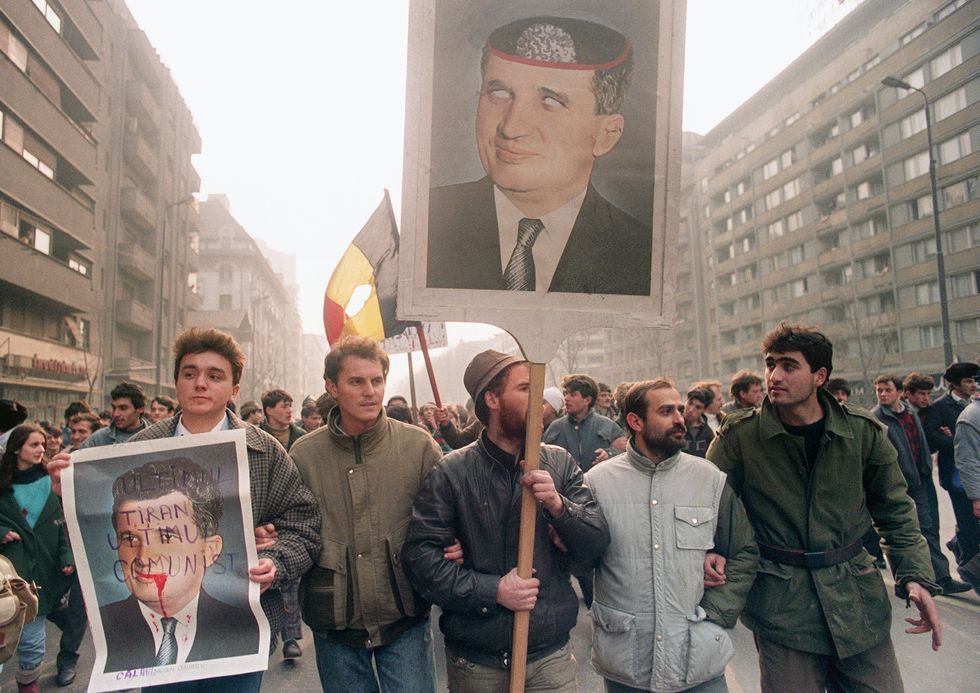 Anti-Communist civilians hold anti-Ceausescu portr