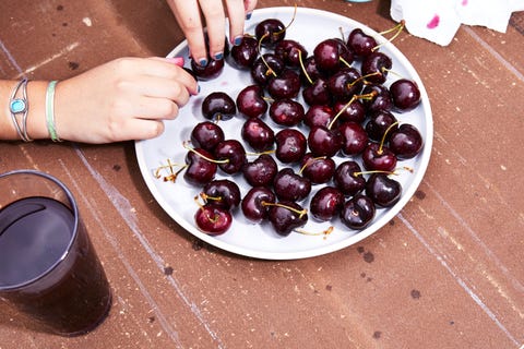 bowl of tart cherries and a glass of cherry juice