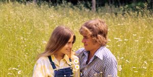 1970s romantic teenage couple sitting in a field of daisies  photo by h armstrong robertsclassicstockgetty images