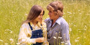 1970s romantic teenage couple sitting in a field of daisies  photo by h armstrong robertsclassicstockgetty images