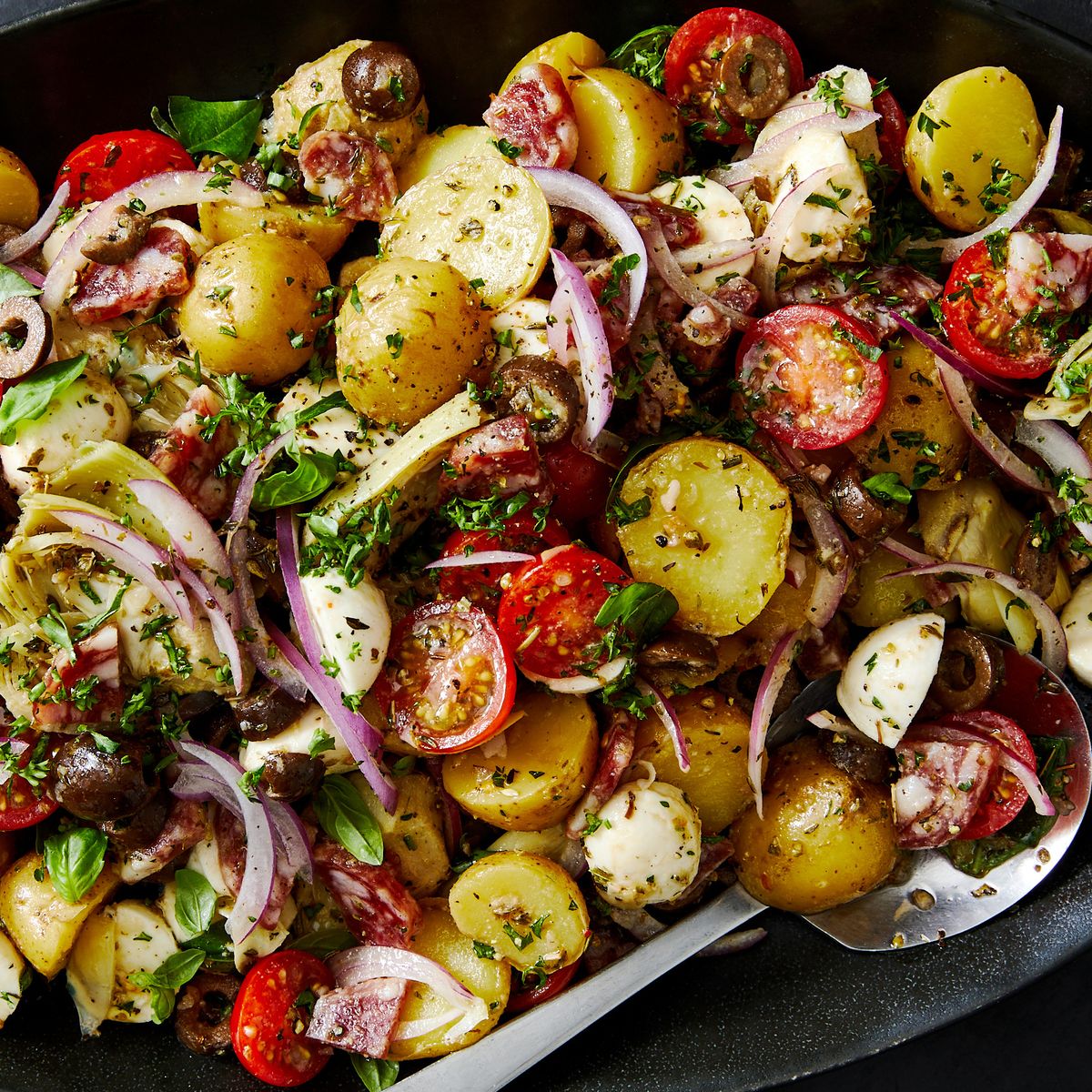 antipasto potato salad tossed together with fresh basil and parsley