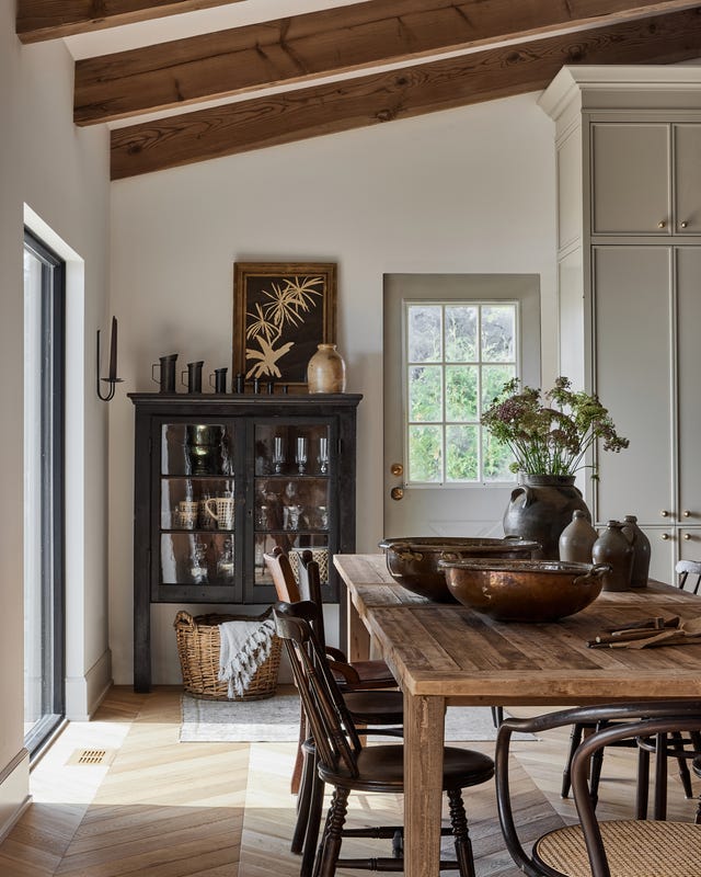 dining room in lake simcoe, ontario, with a collection of antiques. designed by ashley montgomery. antique chairs, antique furniture, antique hutch.