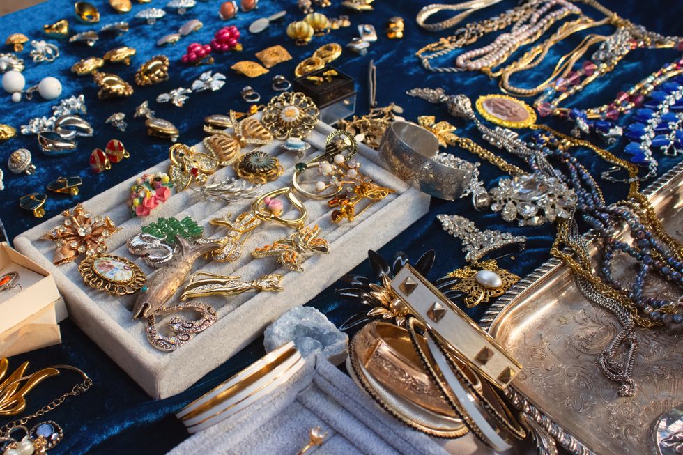 antiques on flea market or seasonal festival vintage jewelry, silver brooches and other vintage things collectibles memorabilia and garage sale concept selective focus