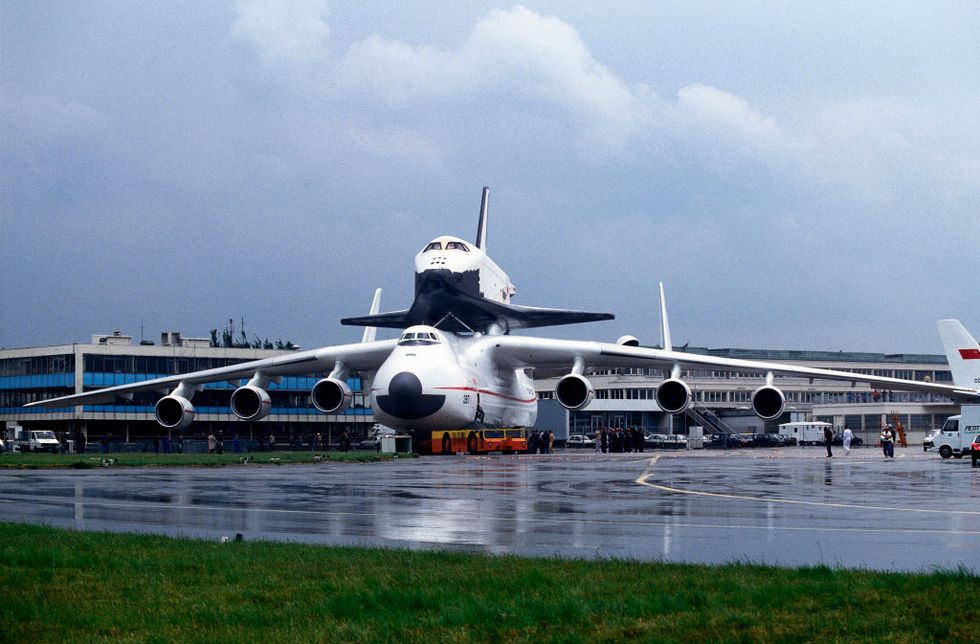 antonov an 225 mriya cossack being towed by a tug with a towbar at the 1989 paris airshow with the soviet buran space shuttle on its back