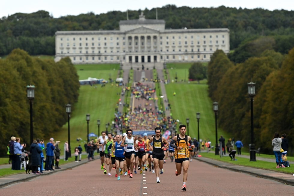 runners at the start of a race with a building in the background