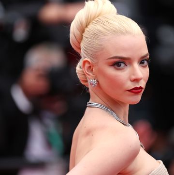 anya taylor joy on red carpet with large bun and blonde hair