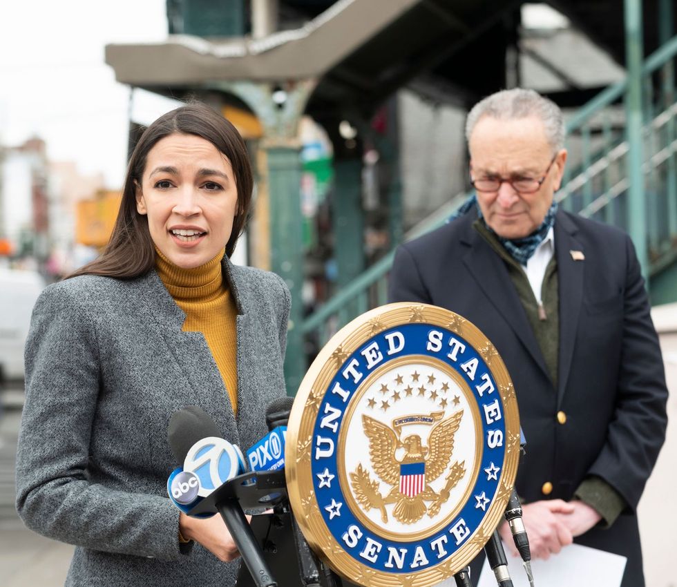 democratic congresswoman from new york alexandria ocasio cortez speaks as senate minority leader chuck schumer listens during a press conference in the corona neighbourhood of queens on april 14, 2020 in new york city   senate minority leader chuck schumer and democratic rep alexandria ocasio cortez hold a press conference amid the coronavirus pandemic to call on the federal emergency management administration fema to begin approving disaster funds to help families in lower income communities and communities of color pay for funeral costs photo by johannes eisele  afp photo by johannes eiseleafp via getty images