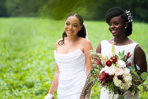 the author and her wife at their wedding holding hands the author and her wife at their wedding holding hands