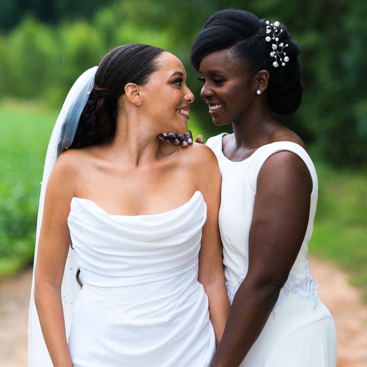 the author and her wife looking at each other while posing at their wedding