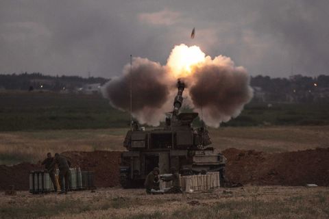 tank firing a rocket at dust in grassland