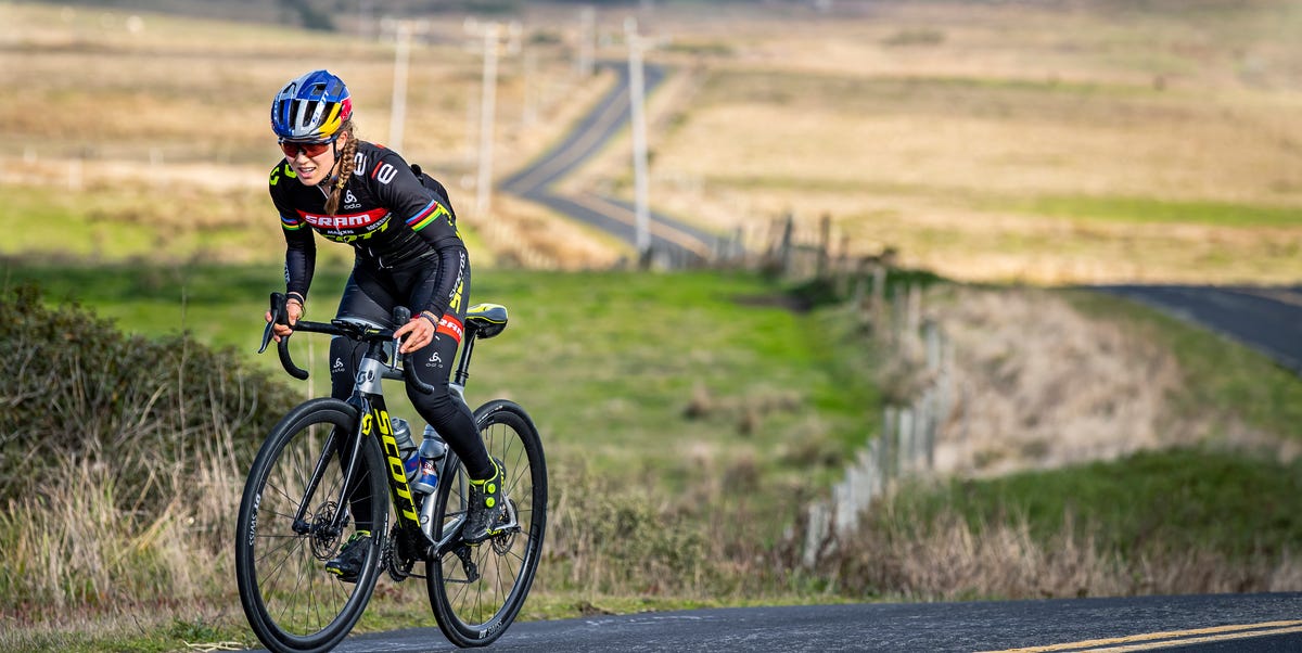 Kate Courtney rides a road bike uphill