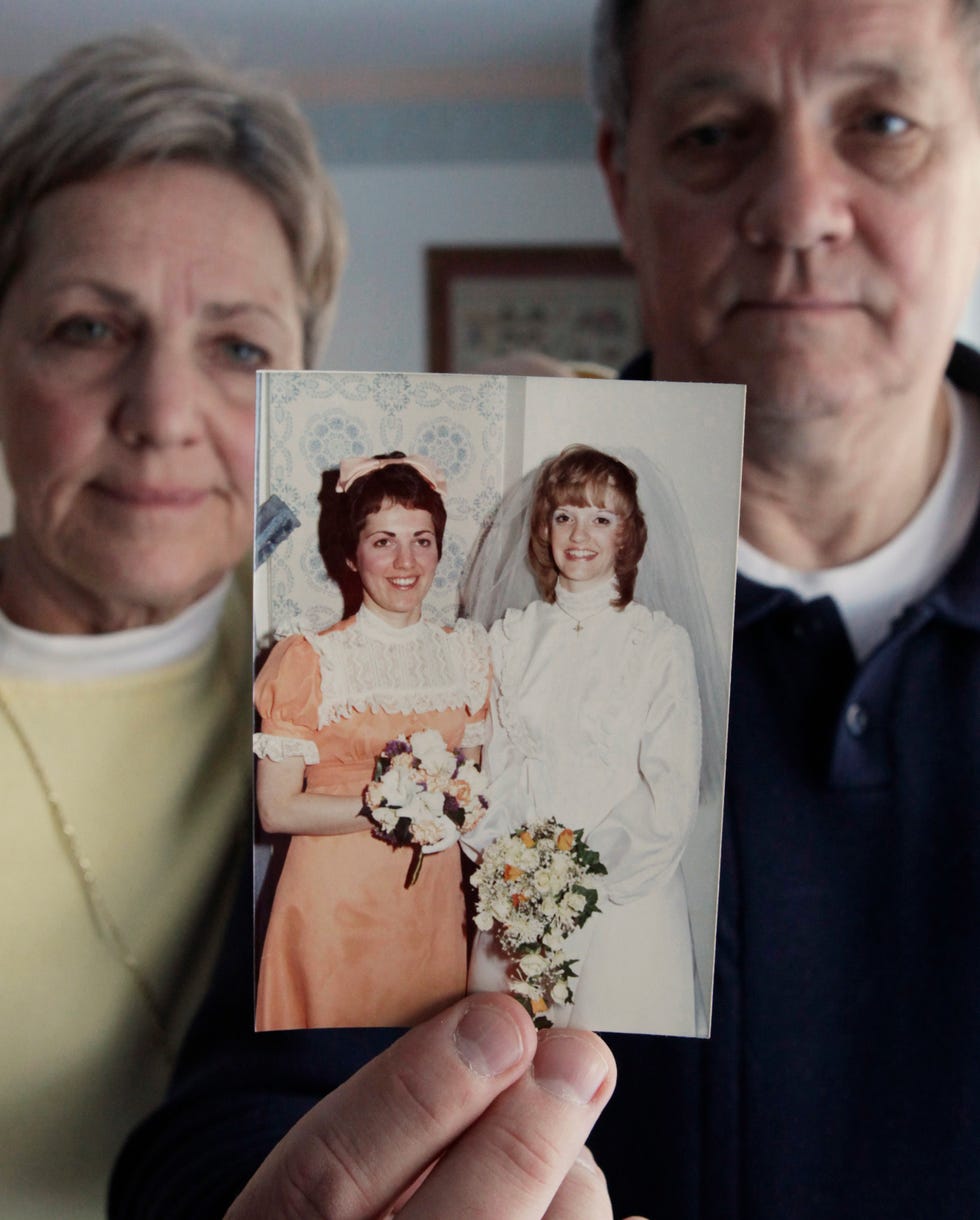 in this feb. 5, 2009 file photo, jack eliason, right, and his wife nancy display a 1974 wedding photo of jack's sister mary mcfarland, right, and nancy as her matron of honor, at the couple's home in elmhurst, ill. mcfarland was one of seven who died from cyanide laced tylenol in 1982. following the feb. 4 raid by the boston area fbi at the home belonging to james w. lewis _ long considered the main suspect in the chicago area crime that terrified the nation in 1982, families of the seven killed have heard nothing on a break in the case.
