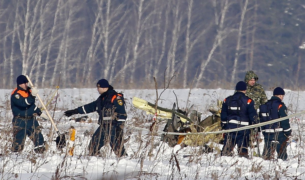 Personnel work at the scene of the AN-148 plane crash in Stepanovskoye village, about 40 kilometers (25 miles) from the Domodedovo airport, Russia, Moday, Feb. 12, 2018. 