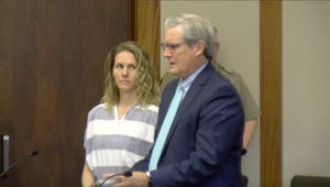 ruby franke wearing striped prison attire and looking over at an attorney during a court hearing