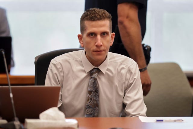 a person sitting at a table in court