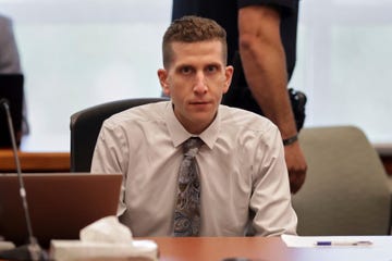 a person sitting at a table in court