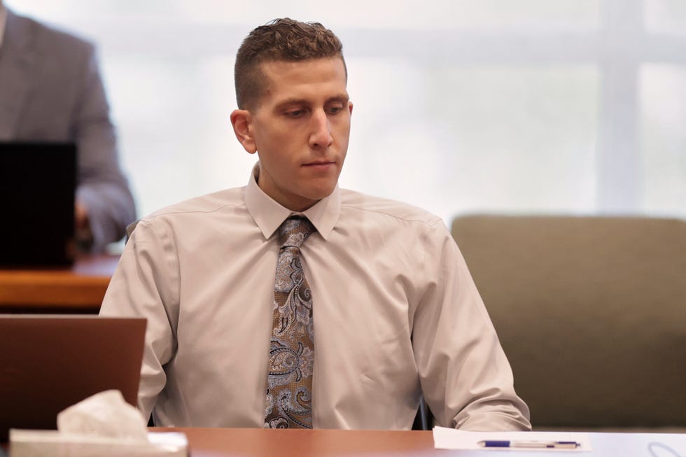 a person sitting at a table in court
