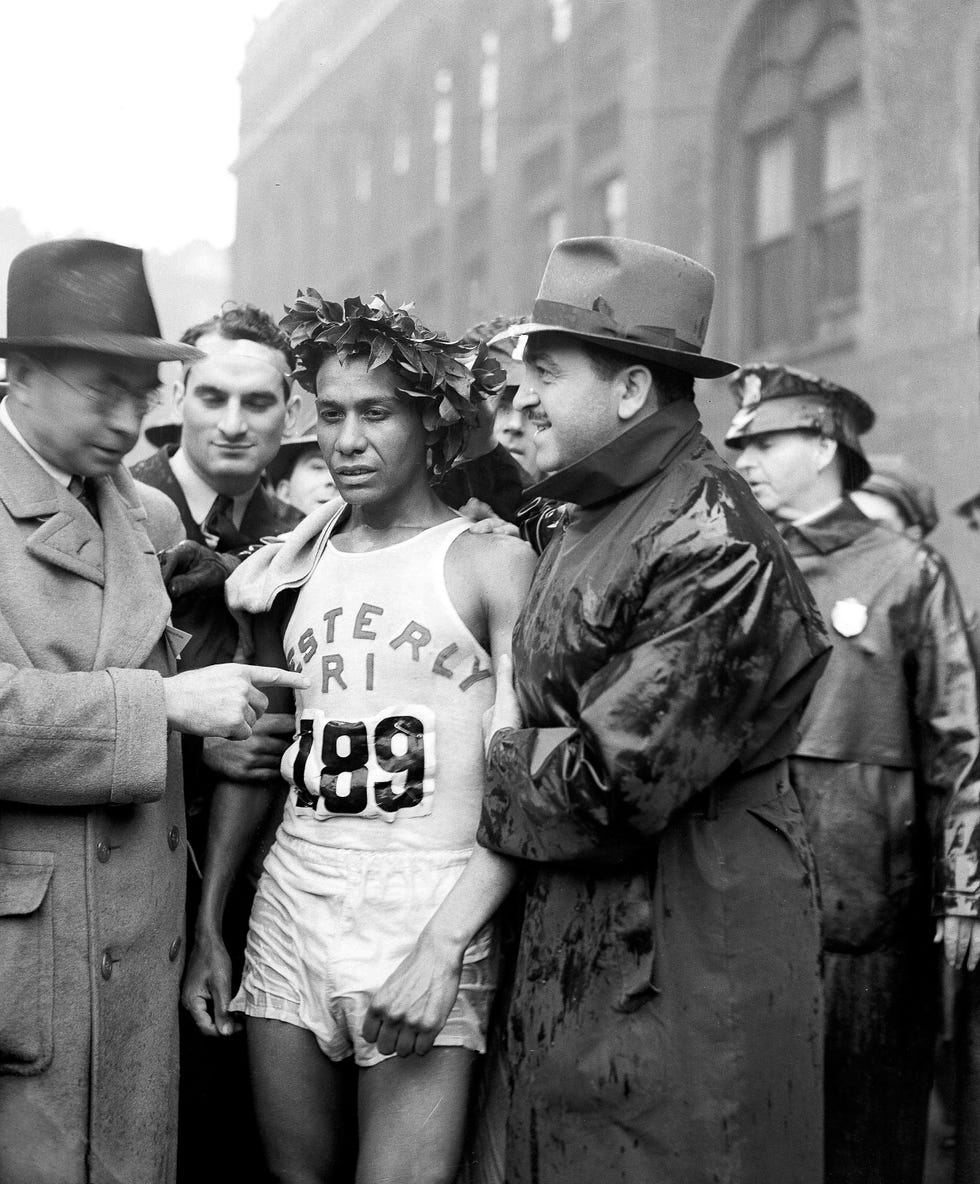 celebration of a race participant in athletic attire surrounded by officials and onlookers