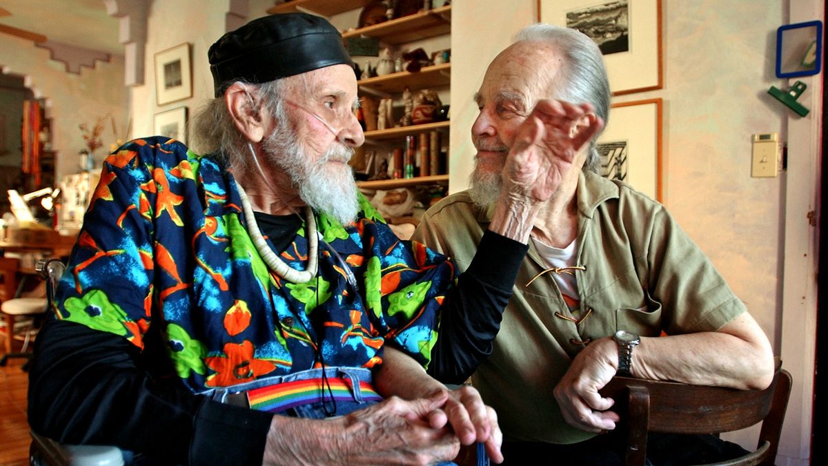 Harry Hay (L) brushes the cheek of his partner John Burnside at their home in San Francisco, July 2002