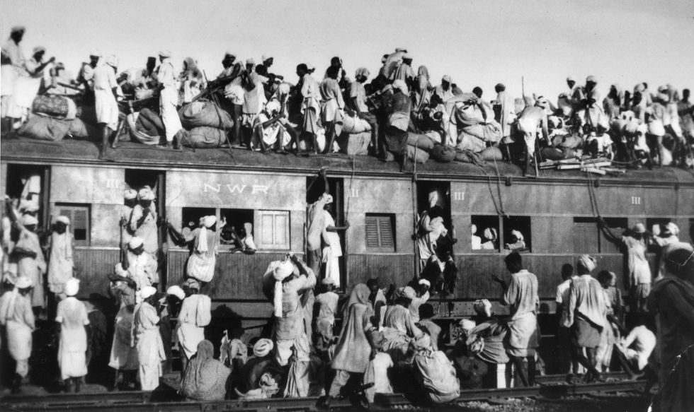 Moslimvluchtelingen zitten op het dak van een overvolle trein in de buurt van New Delhi terwijl ze India proberen te ontvluchten op 19 september 1947 De splitsing verergerde de sluimerende religieuze spanningen op het subcontinent Miljoenen moslims hindoes en sikhs werden uit hun huizen verdreven of gedood tijdens rellen