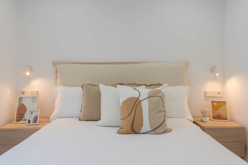 cabecero de lino beige y mesitas de madera