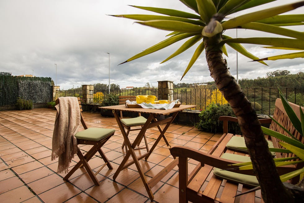 terraza con mesa y sillas plegables de madera
